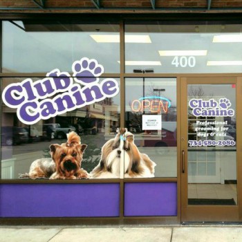Custom vinyl storefront window graphics designed, produced, and installed for Club Canine in Dexter