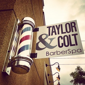 Custom bracketed sign outside Taylor and Colt Barber Spa in Ann Arbor, MI